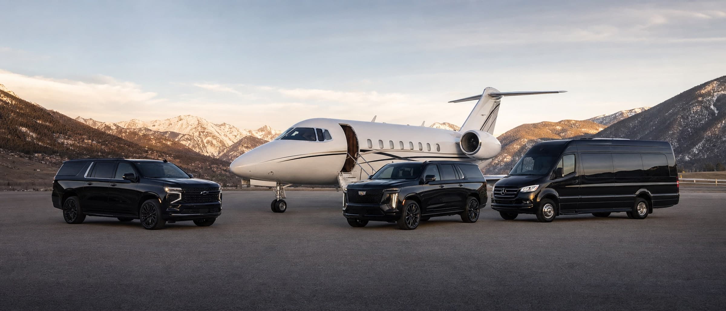 Summit Black Car fleet — Suburban, Escalade, and Sprinter staged with a private jet.